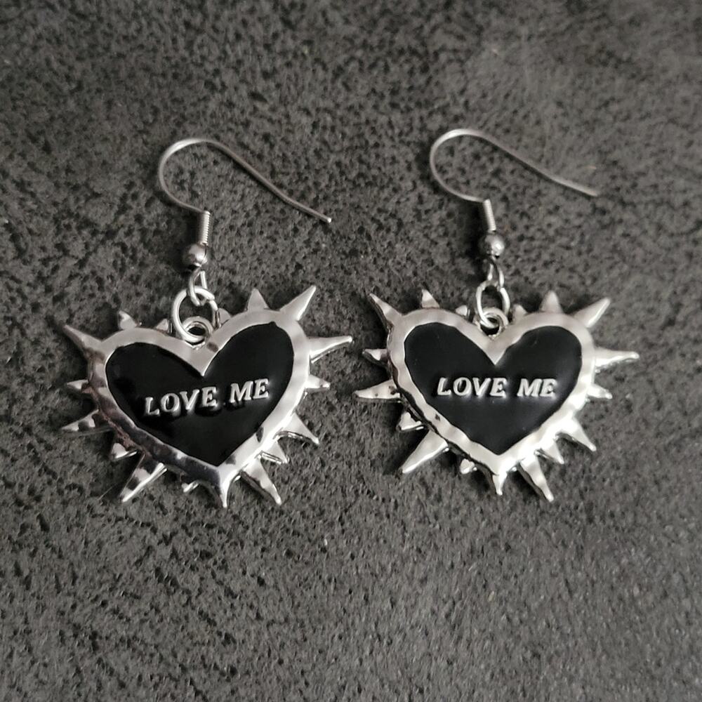 "LOVE ME" 2 sided spiked heart-shaped black and silver earrings